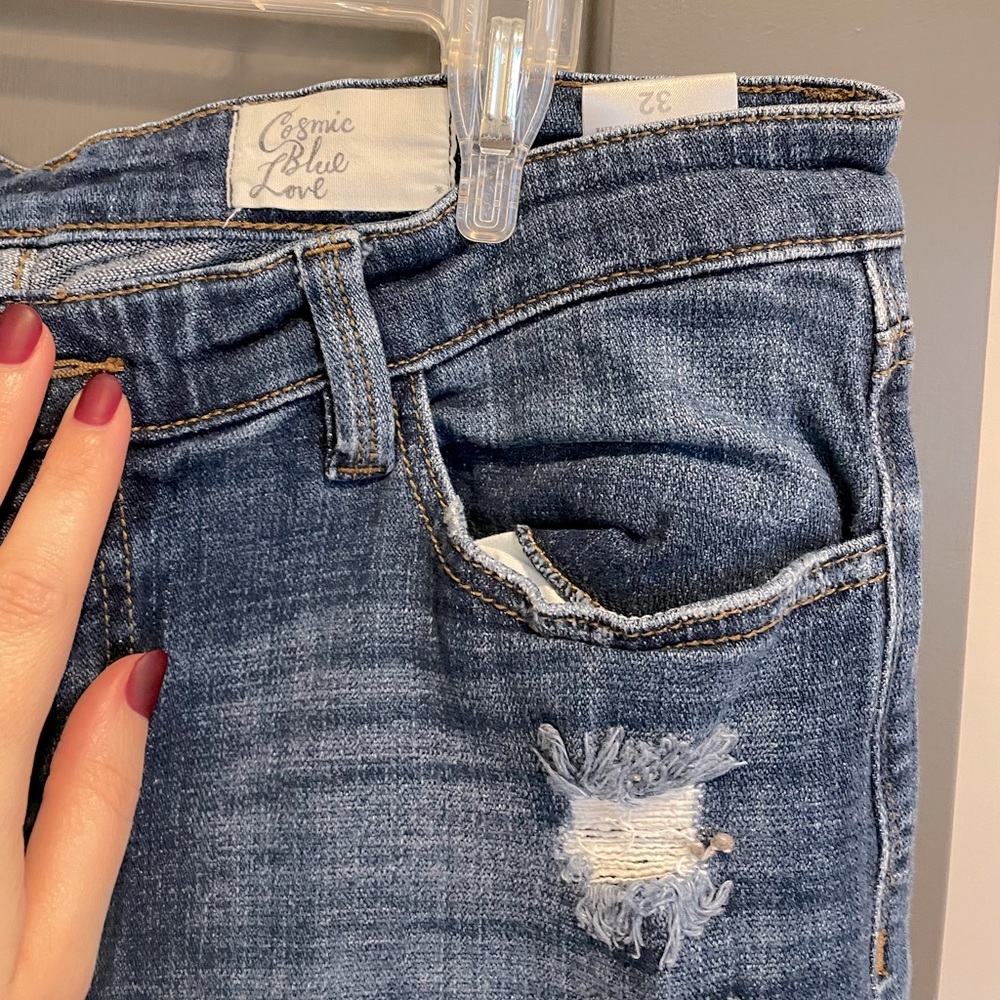 Cropped distressed denim jeans with rolled hem